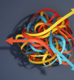 Tangled paper cut blue, yellow and red tapes with arrows pointing different ways. Choice and decisions concept.
